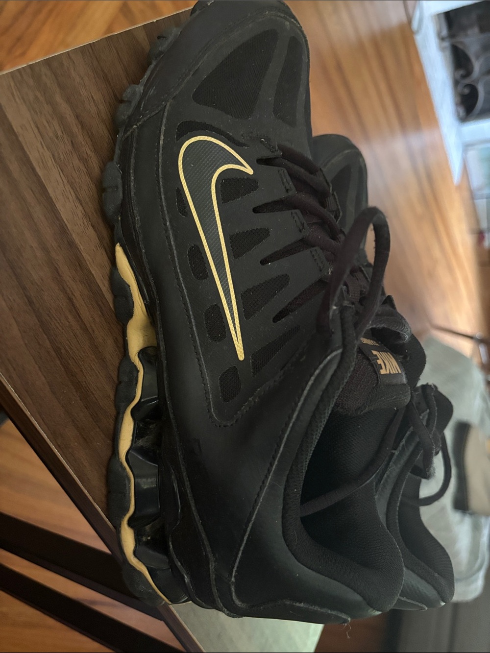 Nike Black and Gold Running Shoes with Swoosh Accent